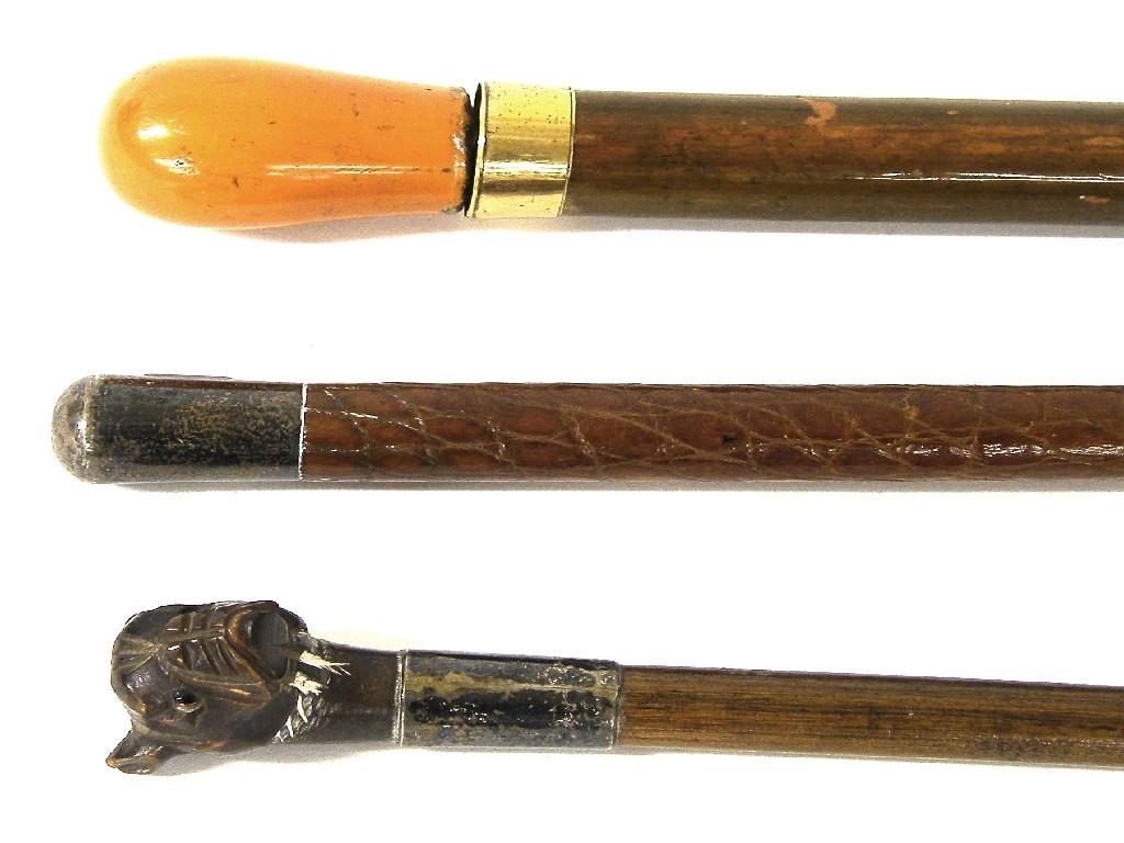 Appraisal: Walking cane with pug carved handle and two other walking