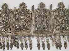 Appraisal: A white metal frontal with embossed images of Hindu deities