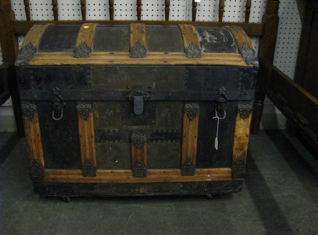 Appraisal: Antique camel back trunk with wood and metal binding on