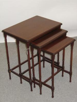 Appraisal: AN EDWARDIAN MAHOGANY NEST OF THREE TABLES of oblong form