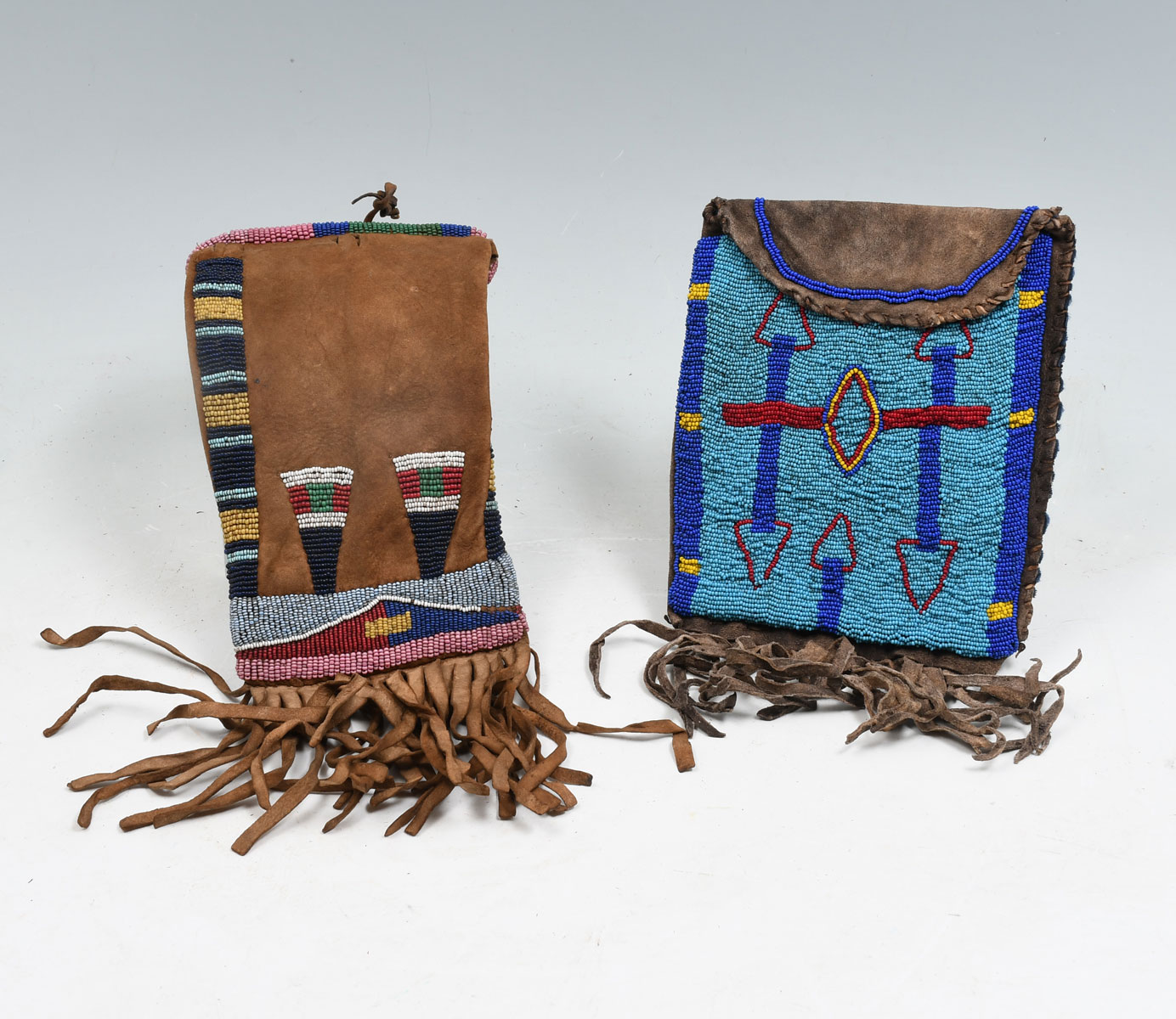 Appraisal: NATIVE AMERICAN INDIAN BEADED HIDE TOBACCO BAGS Tobacco bag beaded