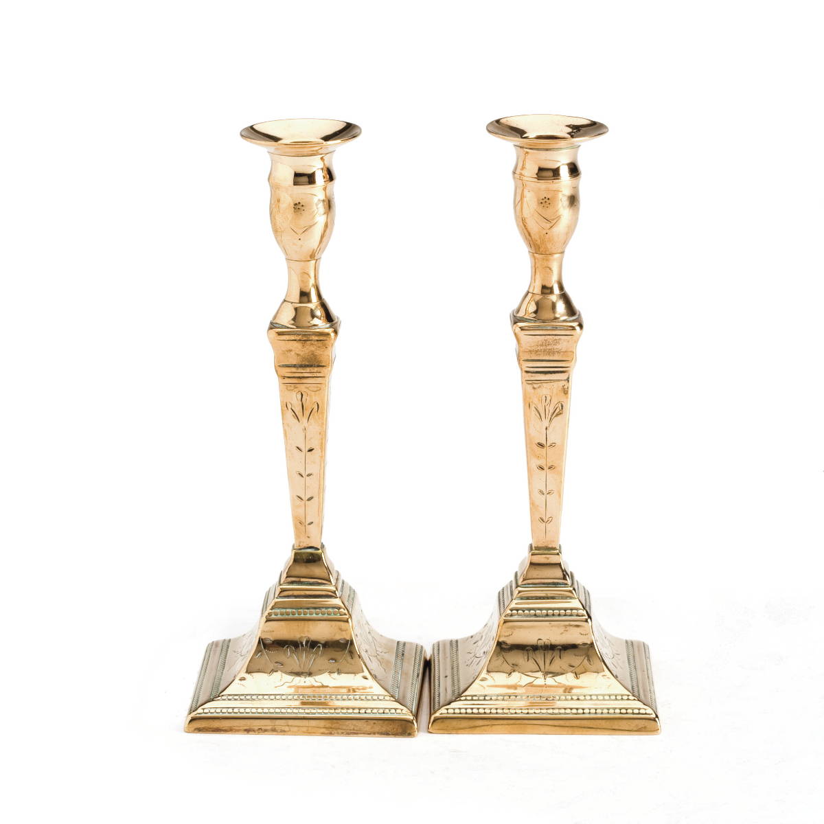 Appraisal: PAIR OF ENGLISH ENGRAVED BRASS CANDLESTICKS IN THE ADAMS STYLE