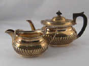 Appraisal: A sterling silver barge shaped half ribbed small teapot with