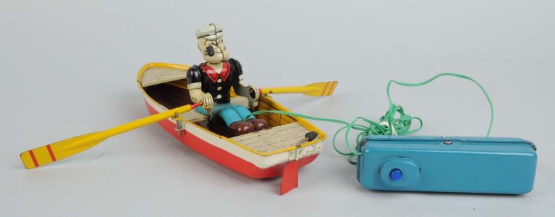 Appraisal: Linemar Tin Litho Battery-Operated Popeye Rowboat Original black rubber pipe