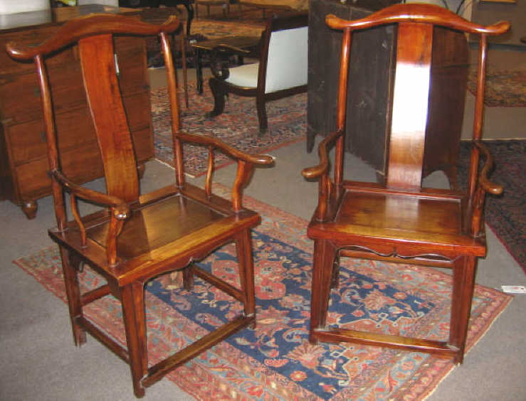 Appraisal: PAIR OF CHINESE YOKE-BACK ARMCHAIRS The rolling top rails over