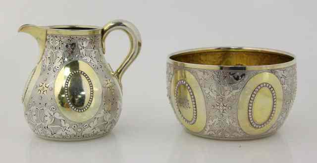 Appraisal: A circular silver sugar basin and matching jug George Fox