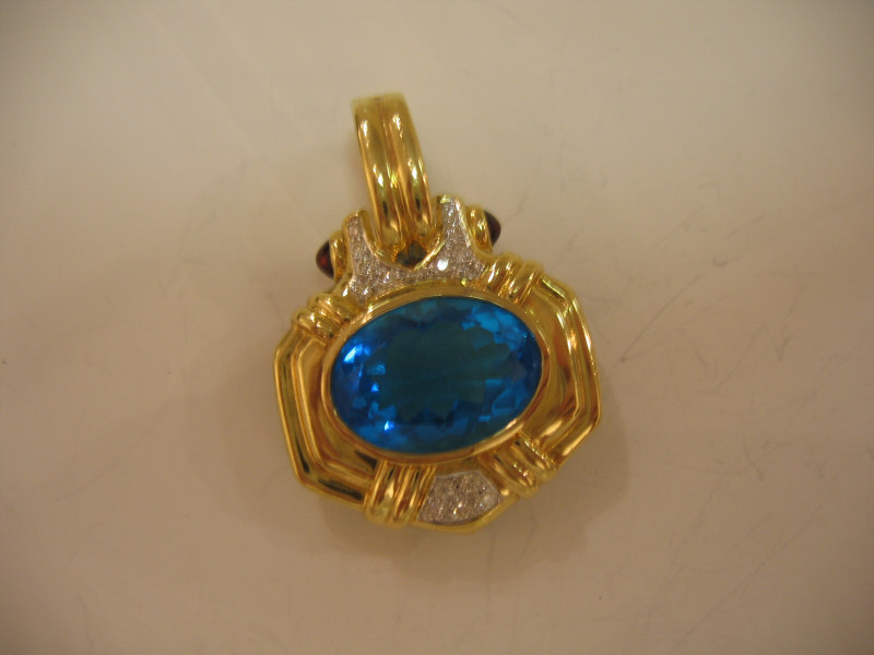 Appraisal: SLIDE PENDANT k yellow gold with oval blue topaz measuring