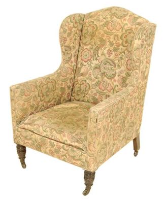 Appraisal: A Victorian wing armchair on turned front supports to ceramic