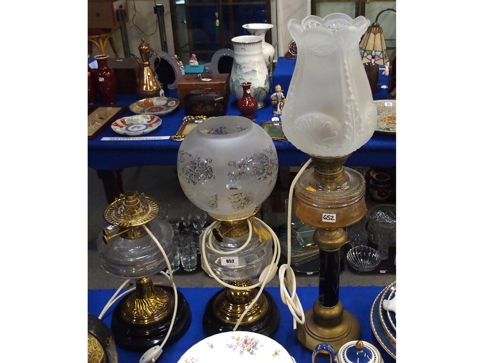 Appraisal: Three late Victorian early th century paraffin lamps with brass