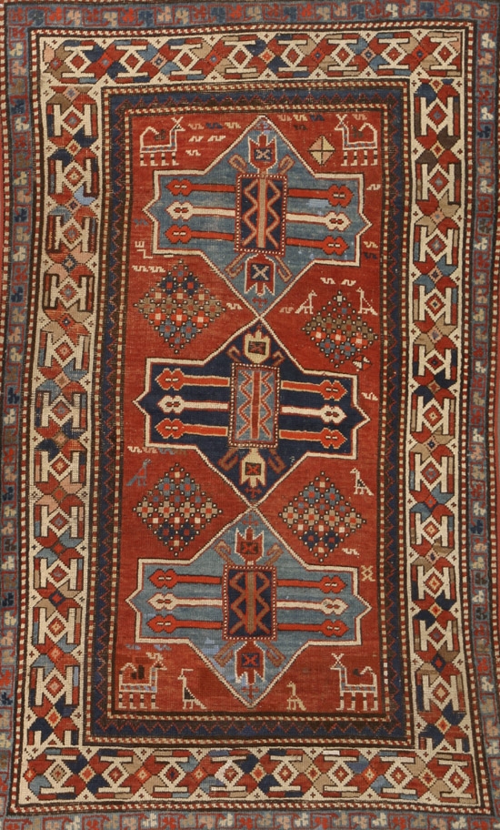 Appraisal: Kazak Rug Circa Red ground with animal and geometric field