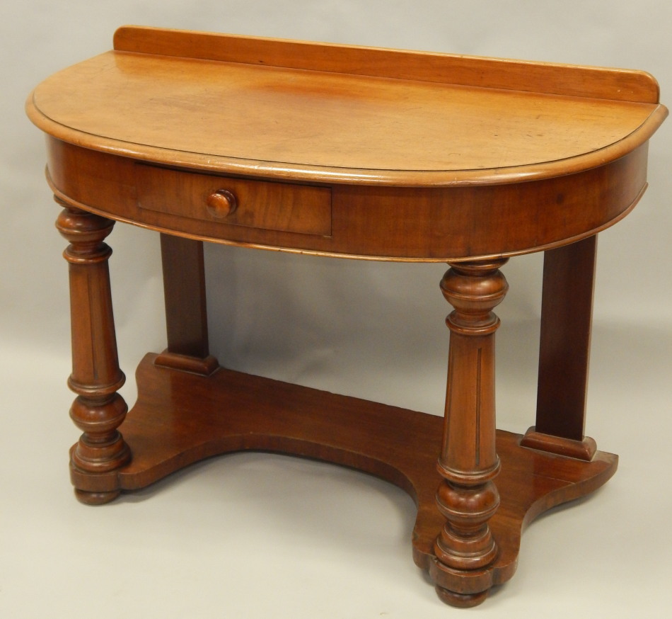 Appraisal: A Victorian mahogany bow fronted wash stand with a frieze