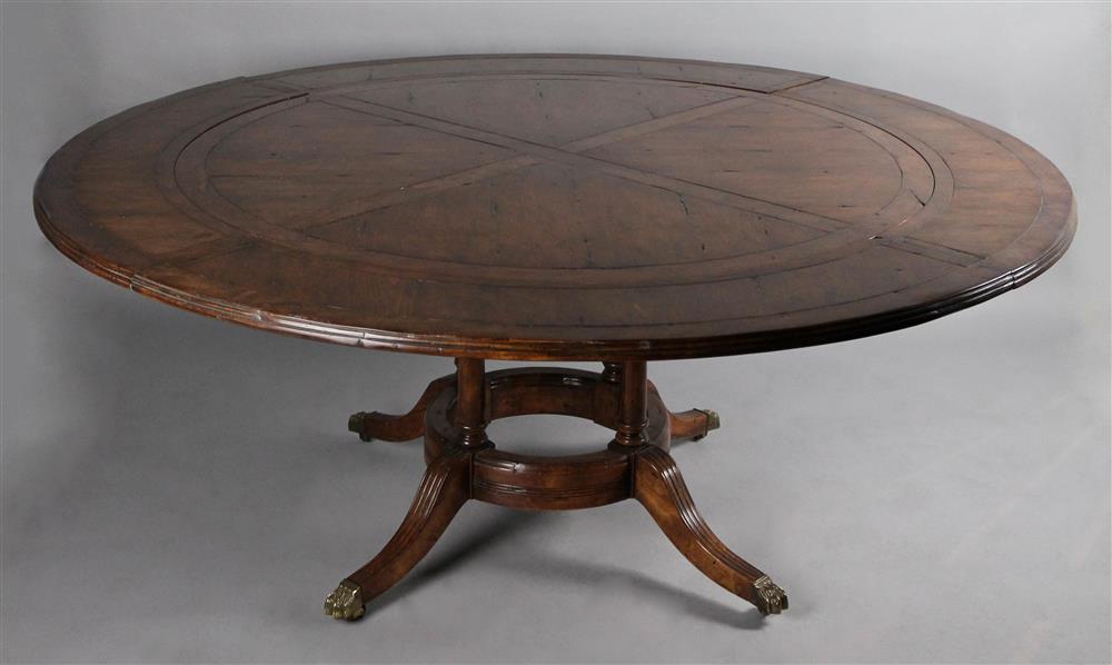 Appraisal: GUY CHADDOCK CIRCULAR CLASSICAL STYLE WALNUT STAINED VENEER DINING TABLE