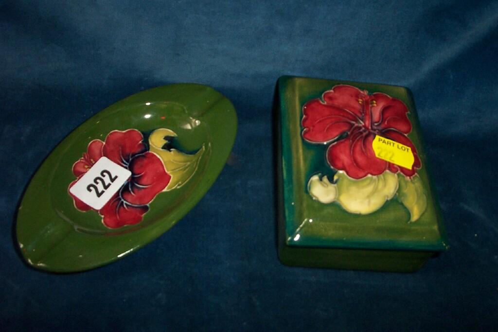 Appraisal: A green ground Moorcroft cigarette box with painted red hibiscus