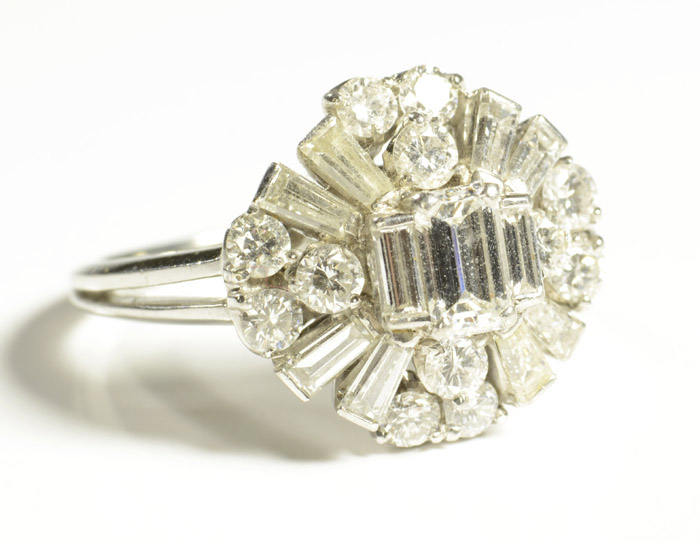 Appraisal: ESTATE DIAMOND AND PLATINUM RING featuring an oval cluster of