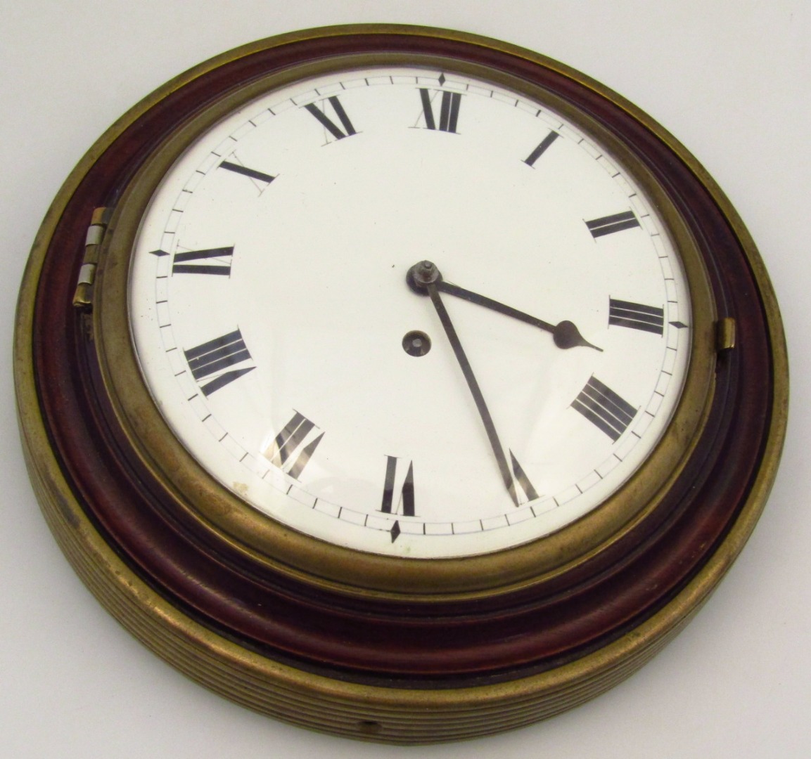 Appraisal: A thC mahogany and brass time piece with circular enamel