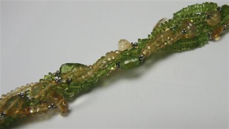 Appraisal: A citrine and peridot torsade composed of several interwoven rows