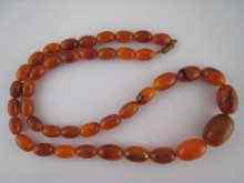 Appraisal: An amber necklace largest bead mm length cm