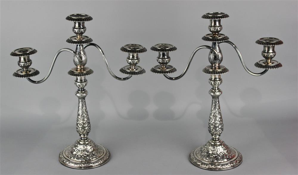 Appraisal: PAIR OF DOMINICK HAFF WEIGHTED SILVER REPOUSSE THREE-LIGHT CANDELABRA retailed