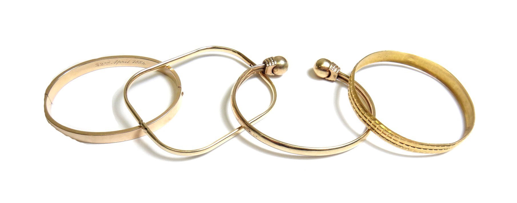 Appraisal: A gold oval hinged bangle on a snap clasp detailed