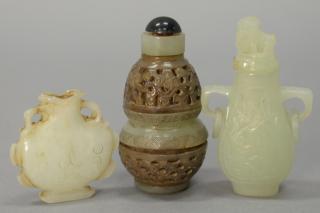 Appraisal: Three carved white and celadon jade snuff bottles one carved