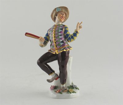 Appraisal: A Meissen model of Harlequin posing before a tree stump