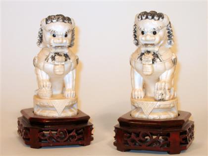 Appraisal: Pair of elephant ivory Fu lions Carved seated ink-work to