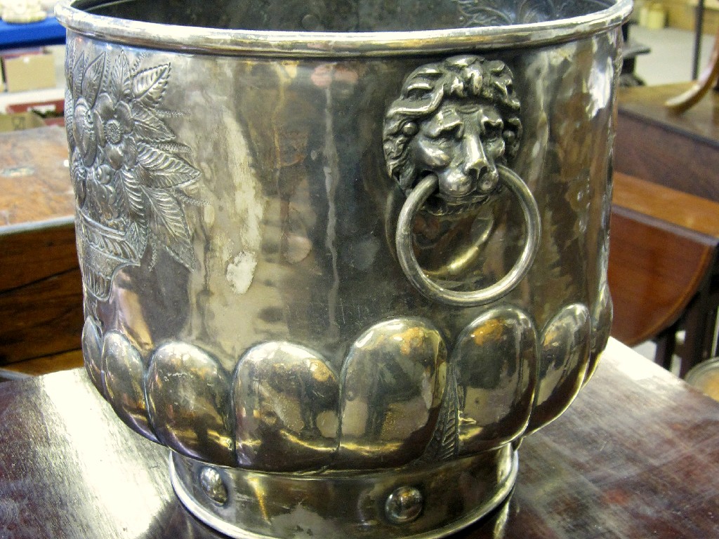 Appraisal: Silvered metal planter with lion's mask handles and armorial crest