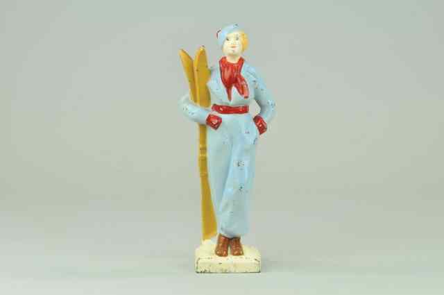 Appraisal: SKIER DOORSTOP BOOK EXAMPLE full figure cast iron woman skier