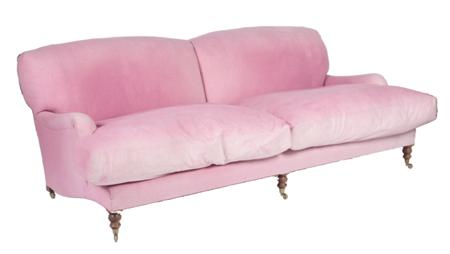 Appraisal: A large faded pink sofa the double arched cushioned back