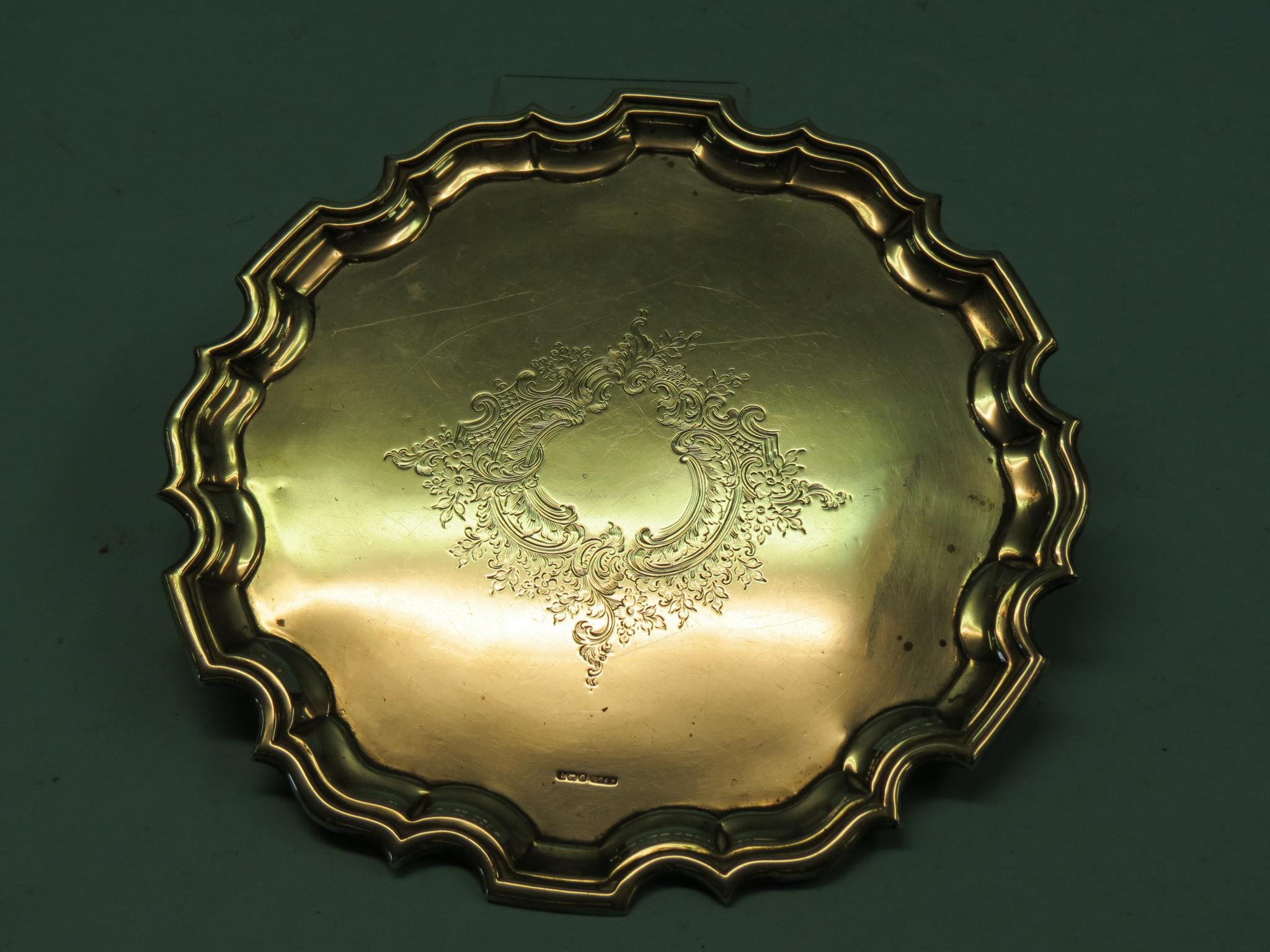 Appraisal: A Georgian-style silver salver with pie-crust border central engraved cartouche