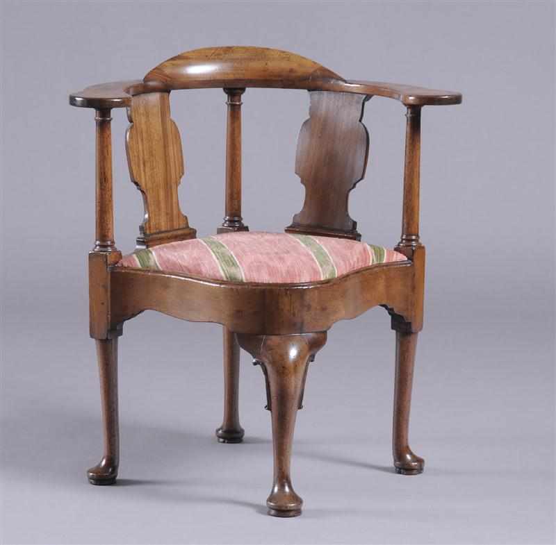 Appraisal: GEORGE II CARVED MAHOGANY CURVED CORNER ARMCHAIR With horseshoe top