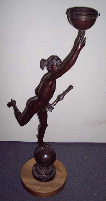 Appraisal: A bronze lamp modelled as Mercury holding aloft a spherical