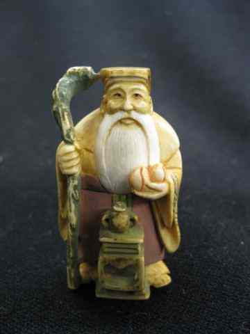 Appraisal: Carved Ivory Netsuke of a Man fancy polychrome signed ''