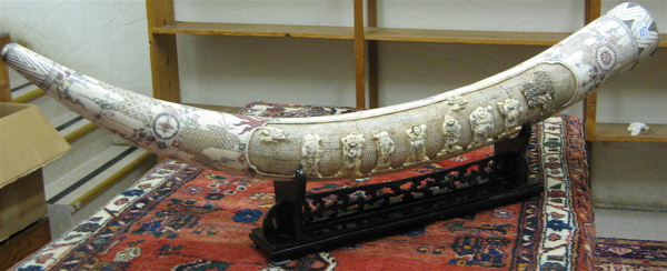 Appraisal: CHINESE RELIEF CARVED AND VENEERED BONE TUSK one side centering