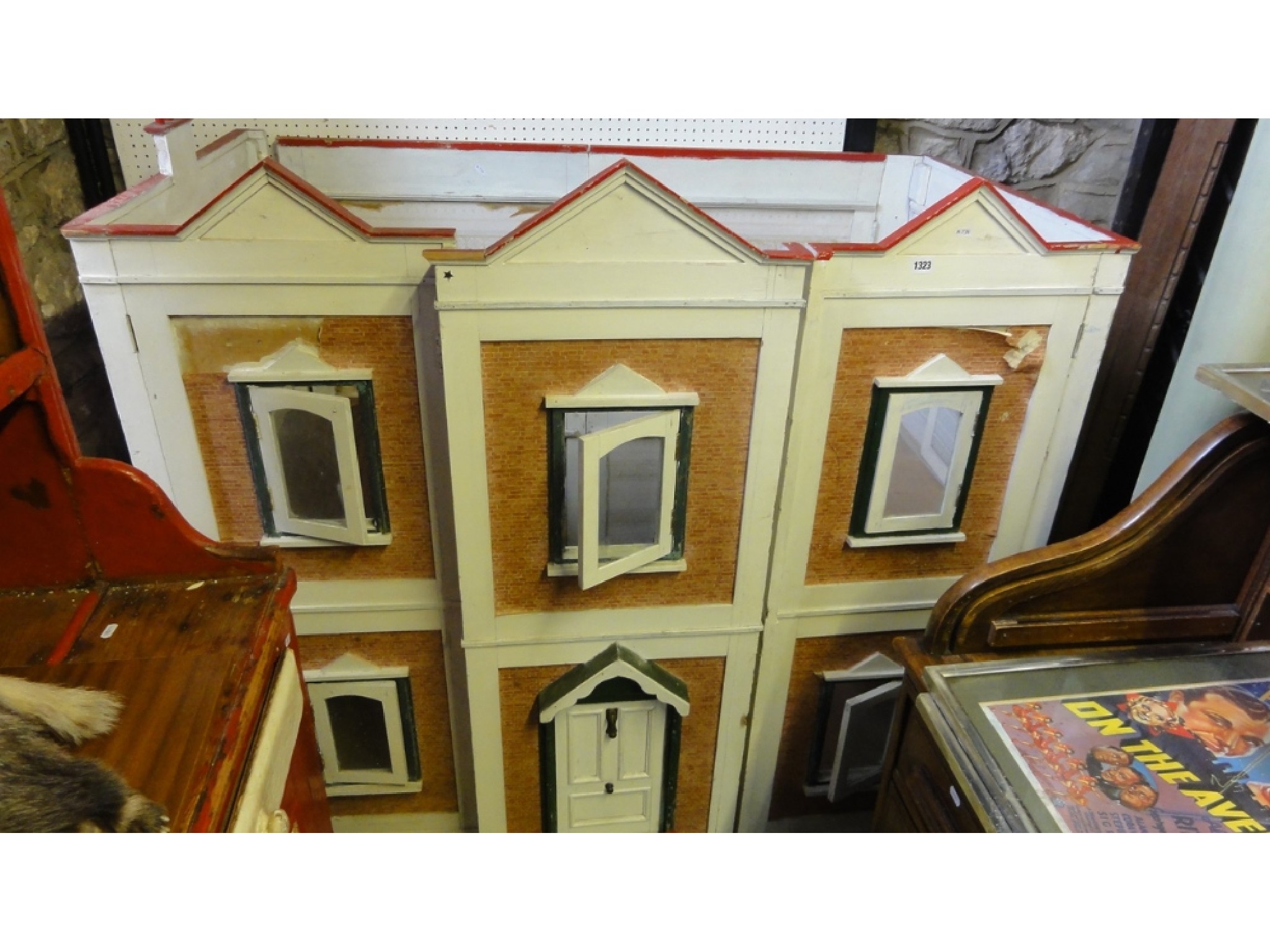 Appraisal: A large freestanding dolls house with folding painted framework and