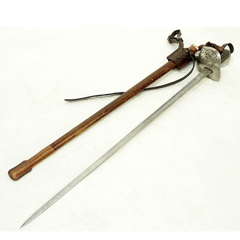 Appraisal: British Officer's Sword British Officer's Sword in Leather Sheath Etched