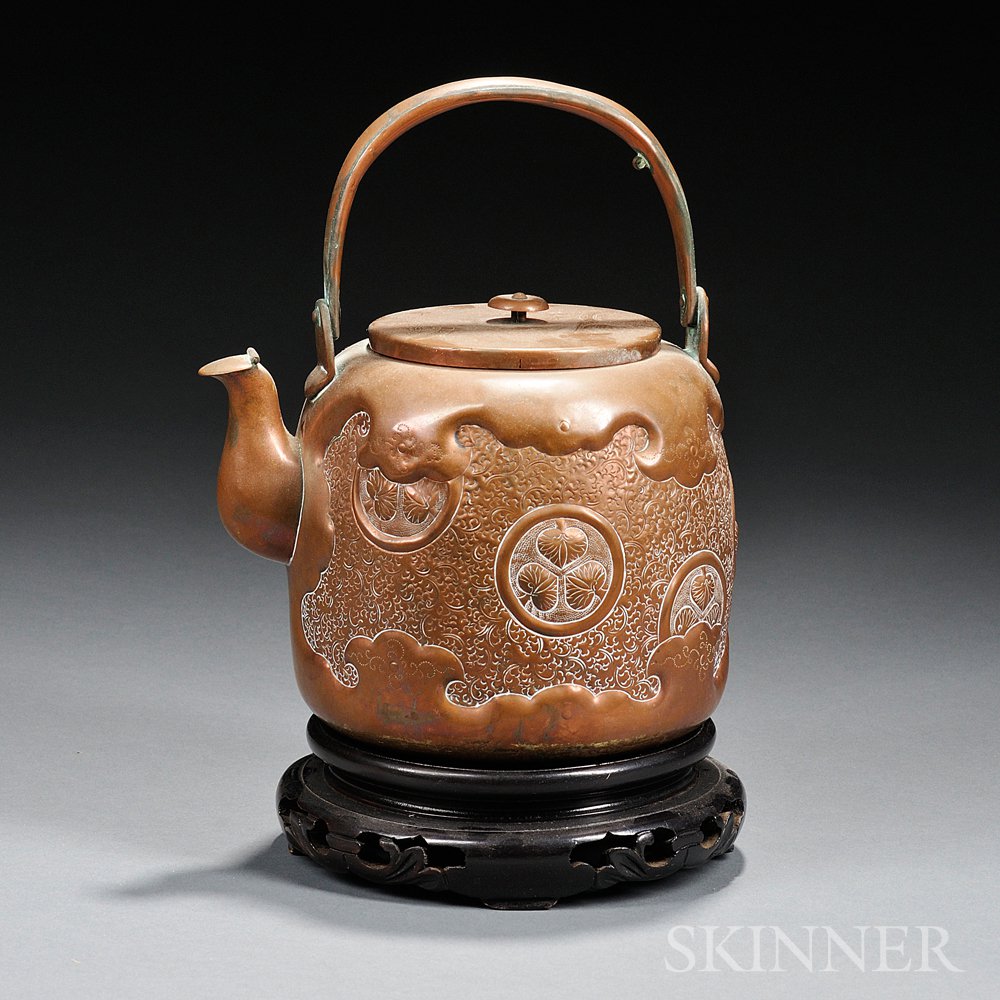 Appraisal: Tin Tea Kettle Japan decorated with roundels containing hollyhock leaves