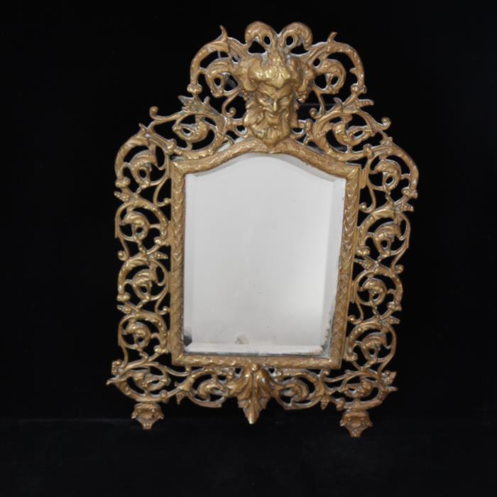 Appraisal: Bronze florentine framed hanging mirror with Bacchus or Mythological head