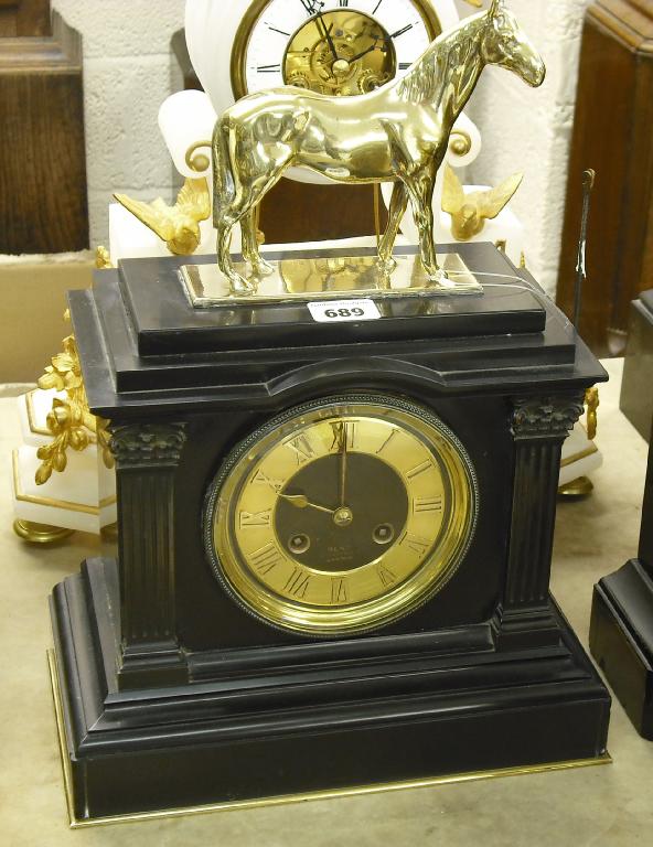 Appraisal: Black marble two train mantel clock the movement striking on