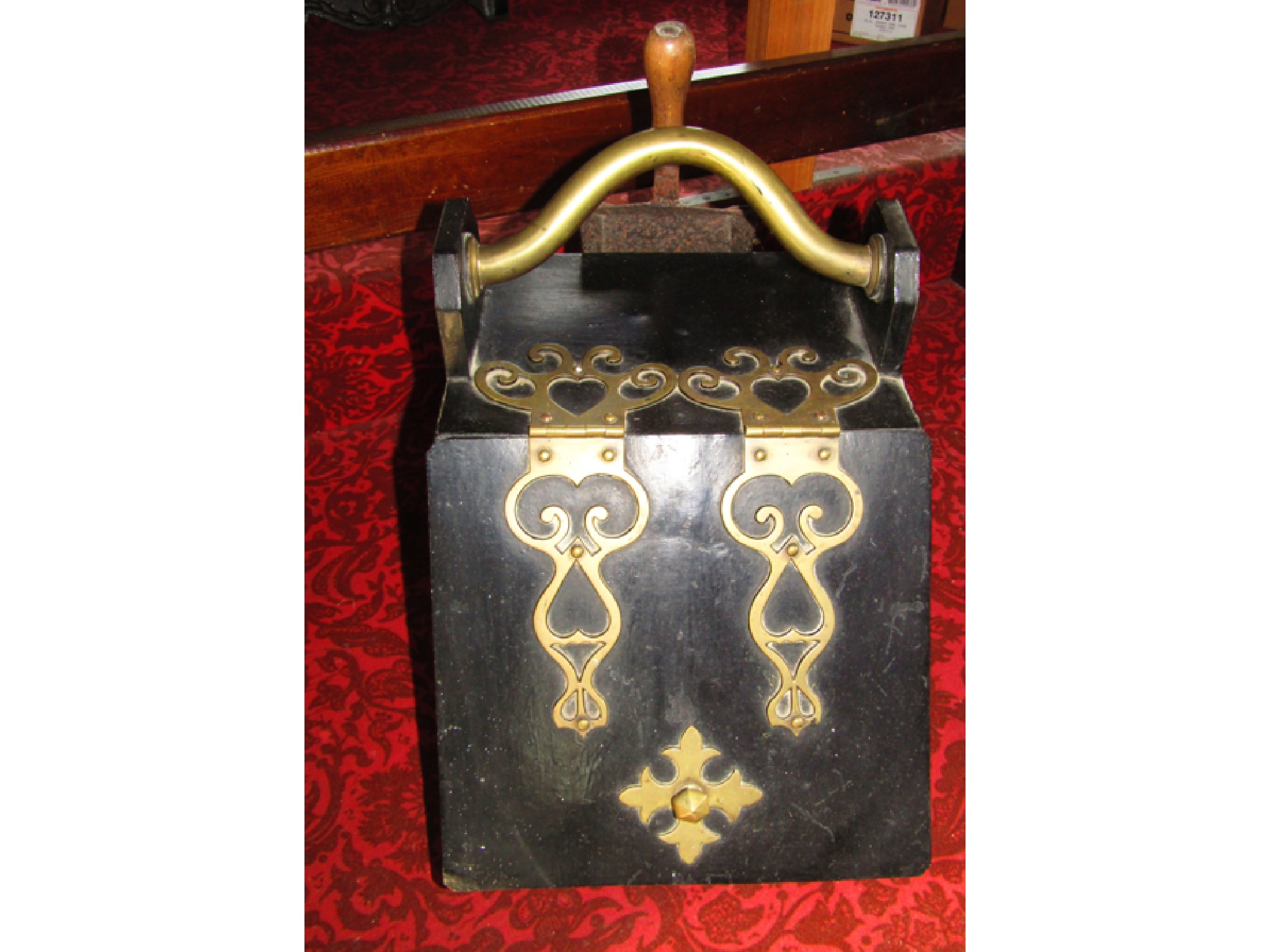 Appraisal: An ebonised Victorian coal scuttle with applied pierced brass hinges