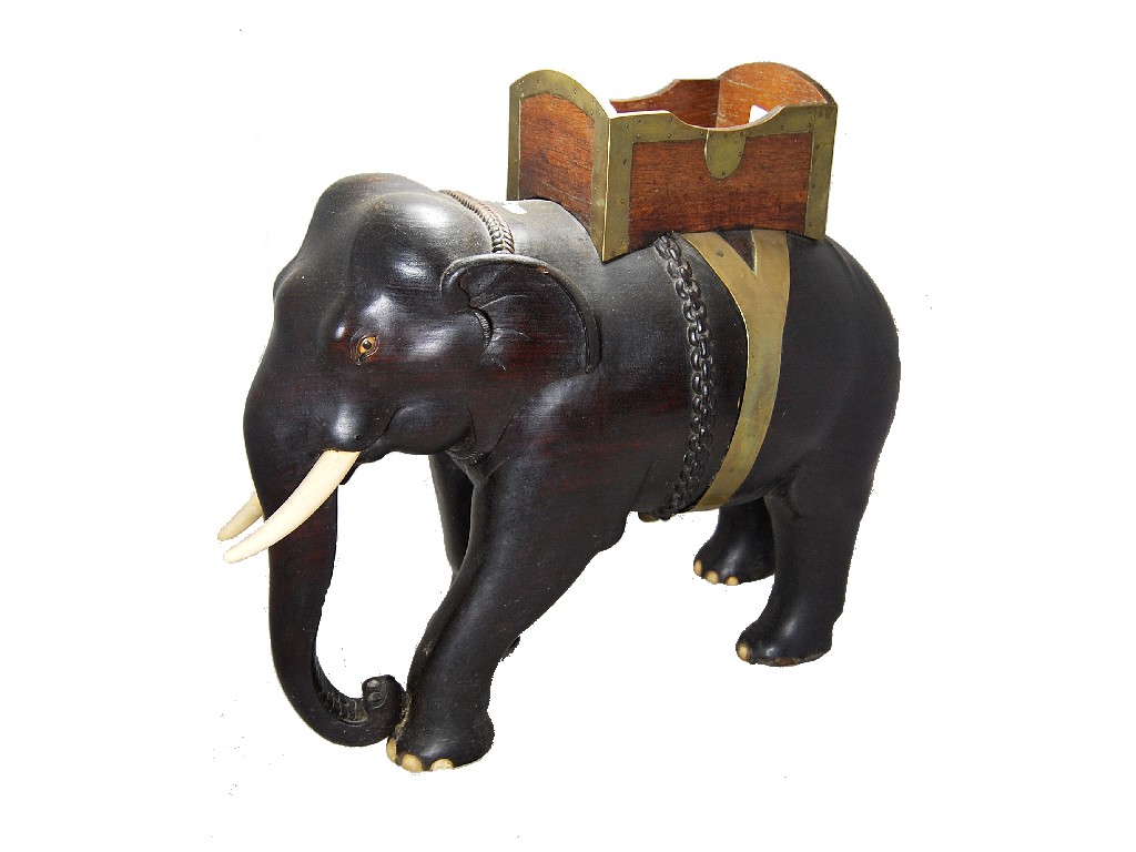 Appraisal: An impressive large carved ebony elephant with ivory tusks and