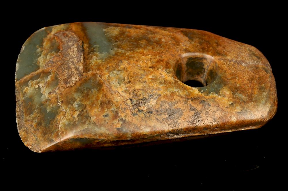 Appraisal: EARLY JADE AXE TOOL The body appears mottled brown and