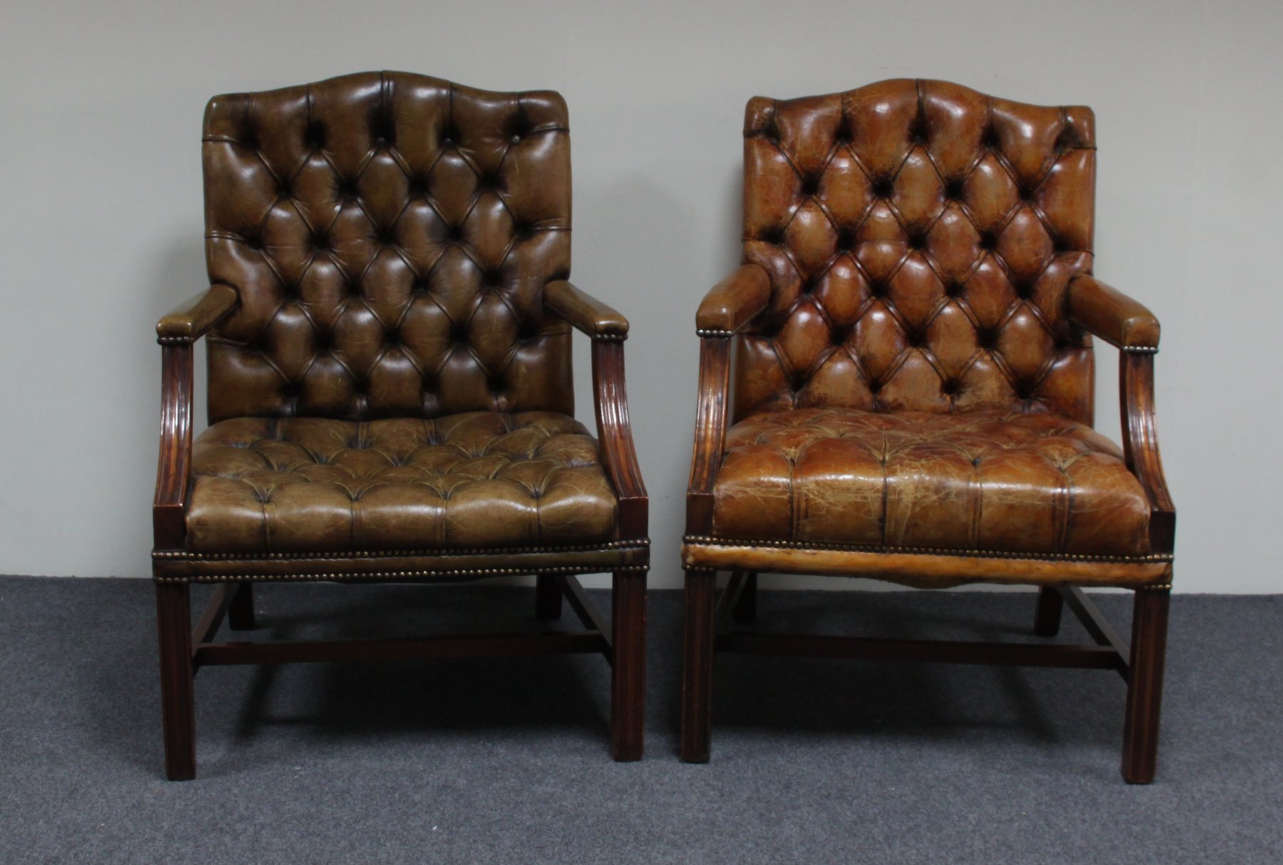 Appraisal: A near pair of George III style Gainsborough armchairs the