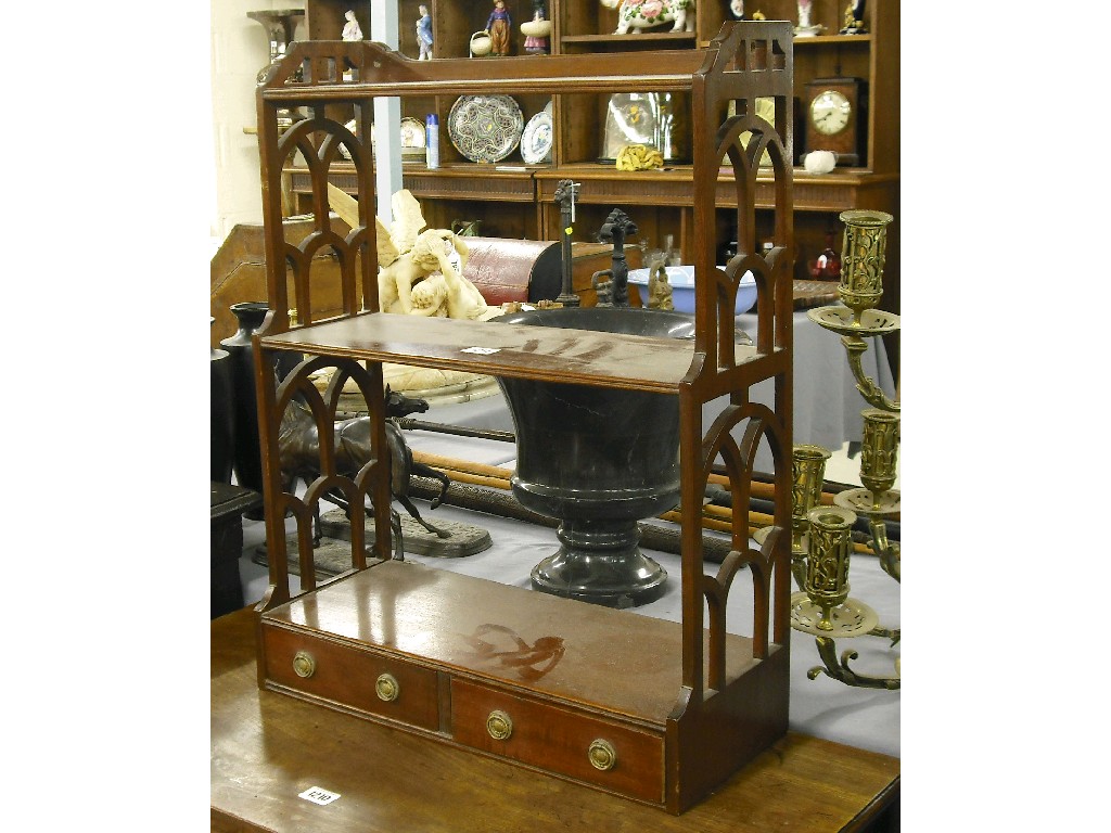 Appraisal: Regency style mahogany hanging bookshelves the lunette pierced sides with