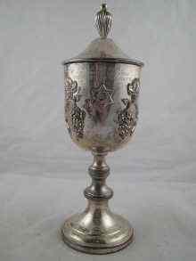 Appraisal: A white metal tests silver cup and cover with applied