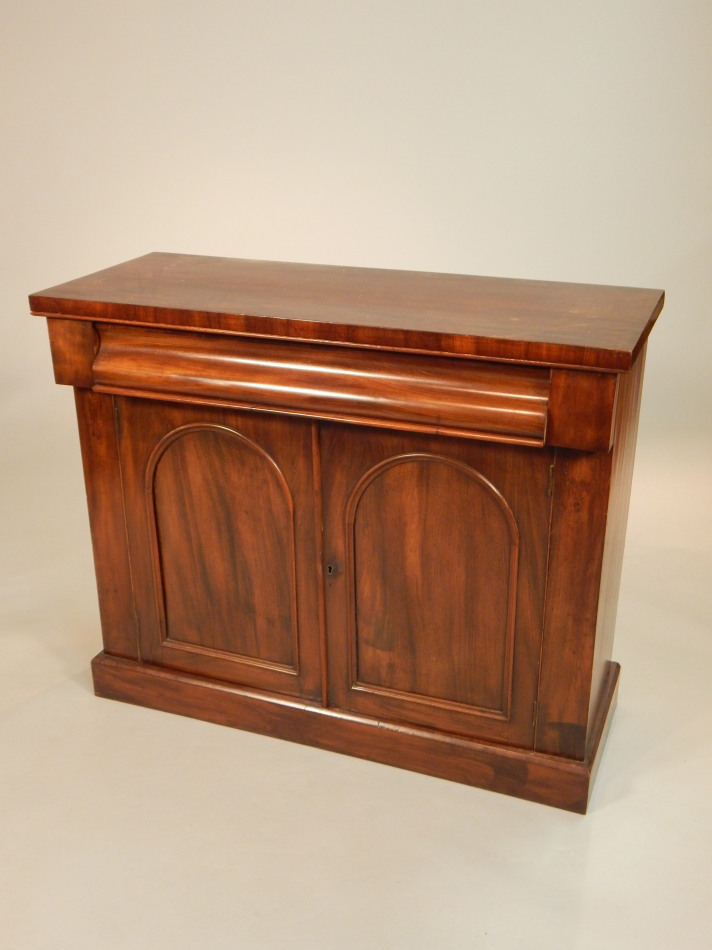 Appraisal: A Victorian mahogany side cabinet with a frieze drawer above