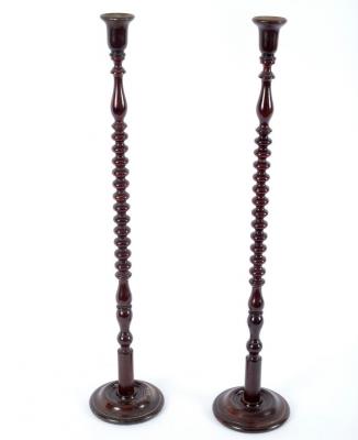 Appraisal: A pair of beech candlesticks with bobbin turned columns and