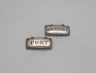 Appraisal: A pair of George III silver wine labels by Hester