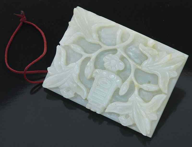 Appraisal: Chinese Ming carved jade belt buckledepicting magnolia and the character