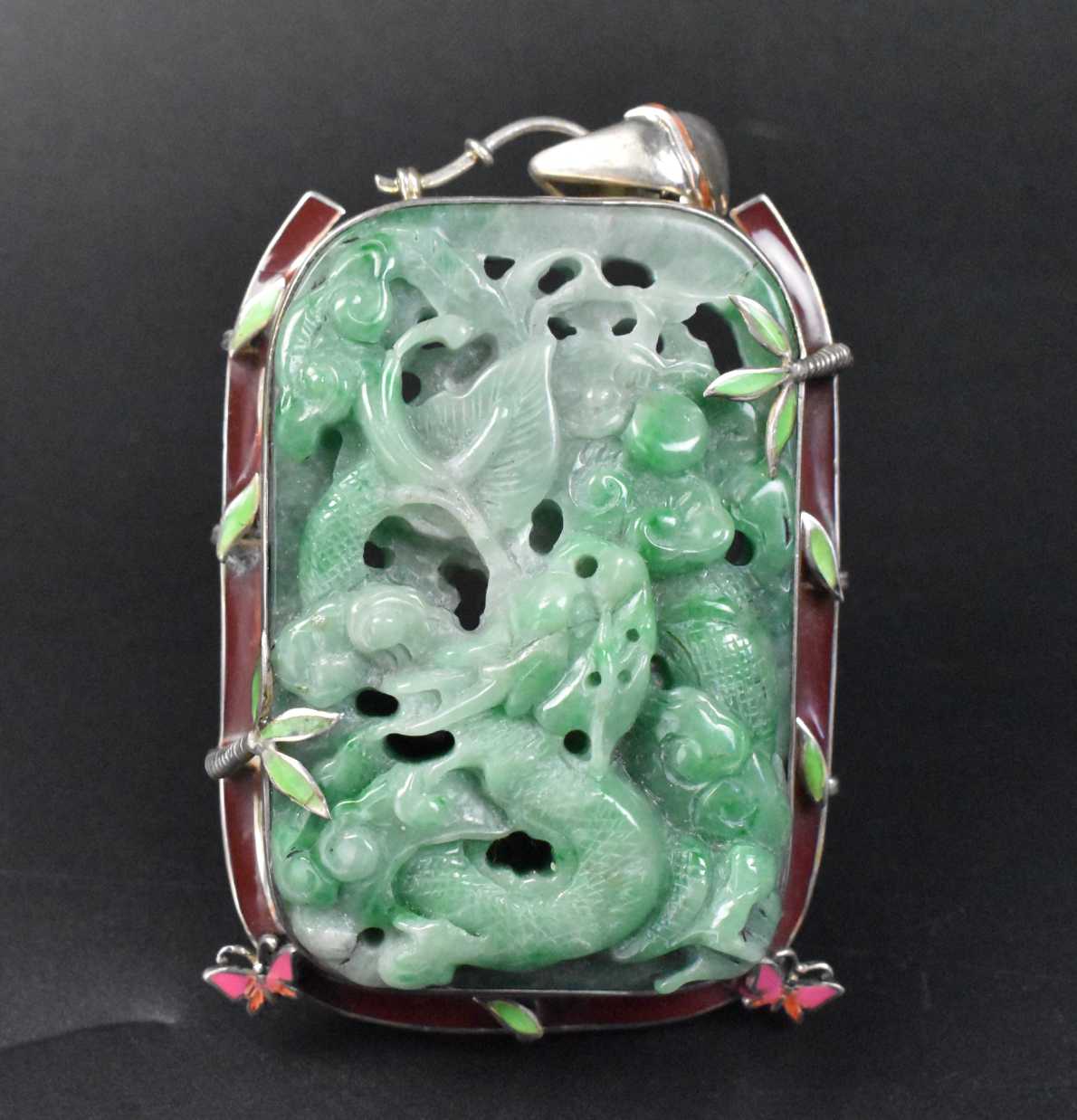 Appraisal: A Chinese jadeite carved dragon pendant with silver frame and